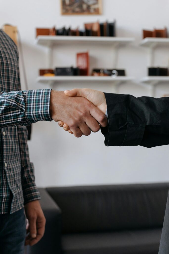 Close-up of a handshake between two adults, symbolizing agreement and partnership.